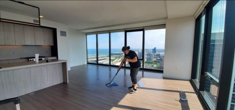 Expert OCD Cleaning employee mopping a hardwood floor in an apartment. The best move-in/ move-out services in Lincoln Square