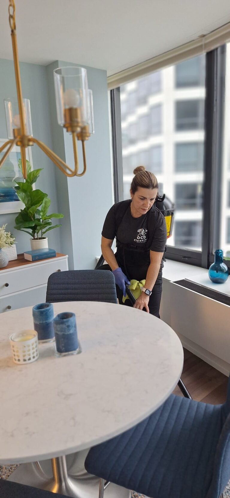 OCD technician vacuuming an apartment. Cleaning services in Avondale