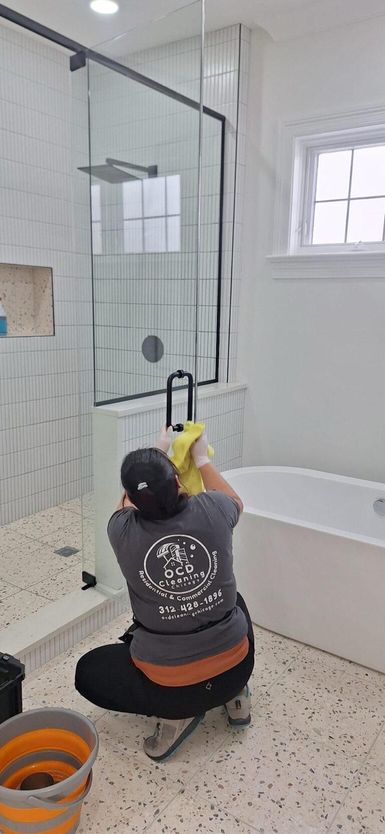 OCD Cleaning technician deep cleaning a bathroom. The best deep cleaning in Uptown Chicago