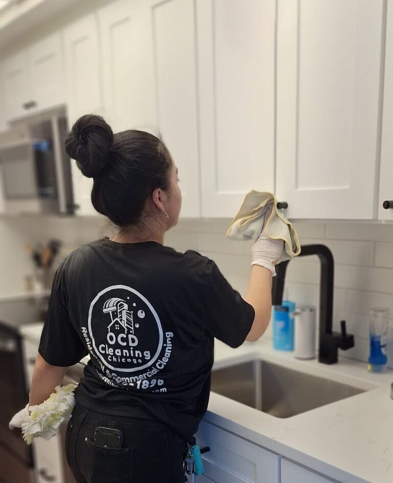 OCD Cleaning expert wiping down a kitchen faucet, highlighting excellent attention to detail and a high level of care. Apartment cleaning in Rogers Park