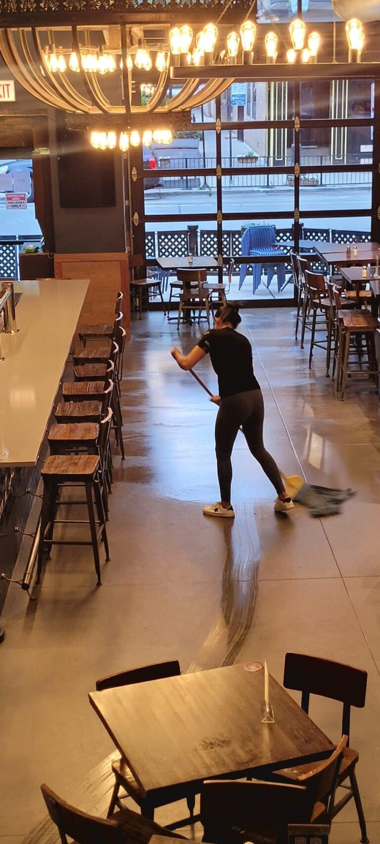 OCD Cleaning technician mopping a restaurant floor