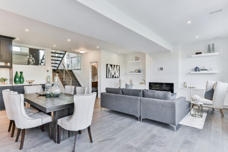 OCD Cleaning, the best house cleaning service providers in Chicago. Showcasing a white and gray monochromatic open-concept area with a kitchen, dining room, and living room. House cleaning services in Logan Square