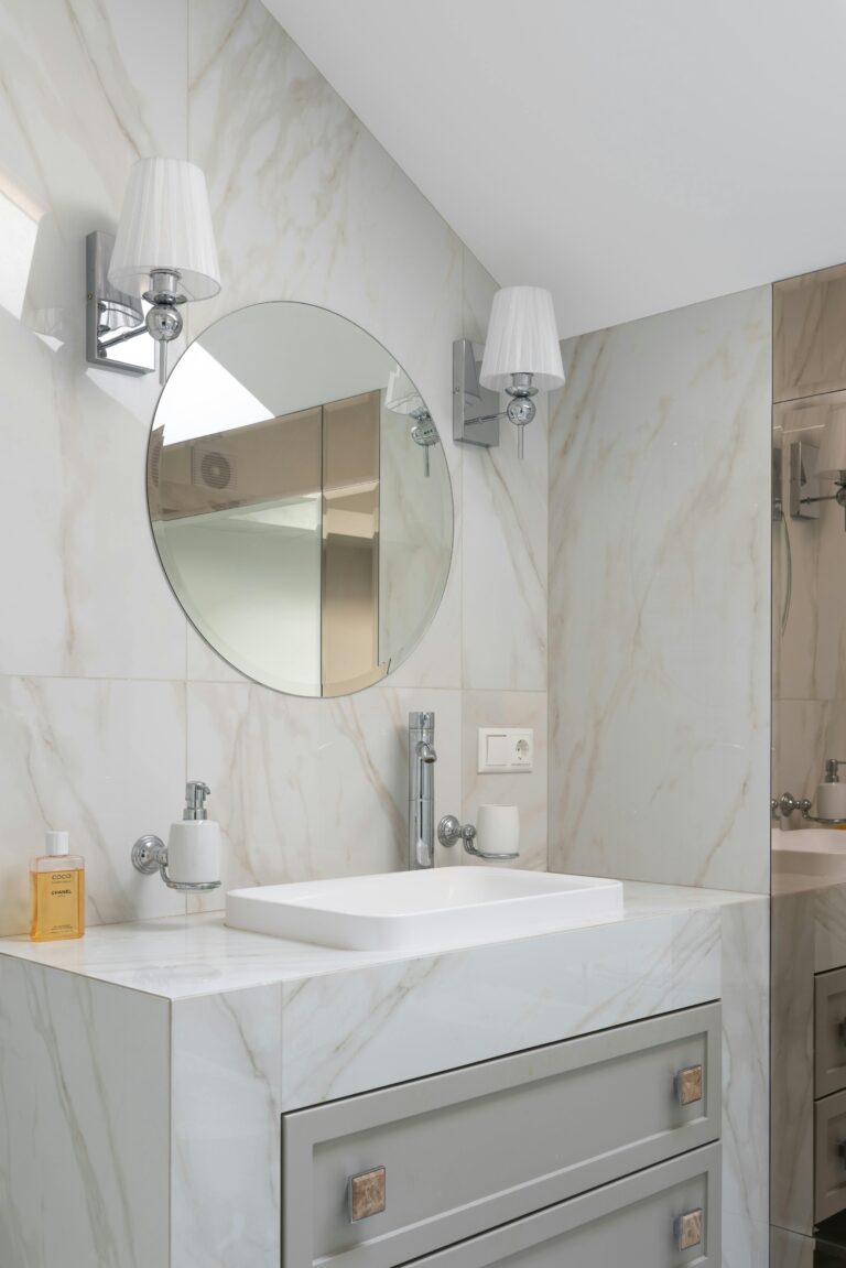 a bathroom with a round mirror and a sink. Deep cleaning in Near West Side.