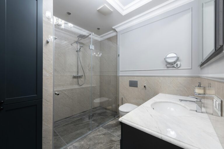 a bathroom with a glass shower and a toilet. Move-in/move-out cleaning services in Near West Side.