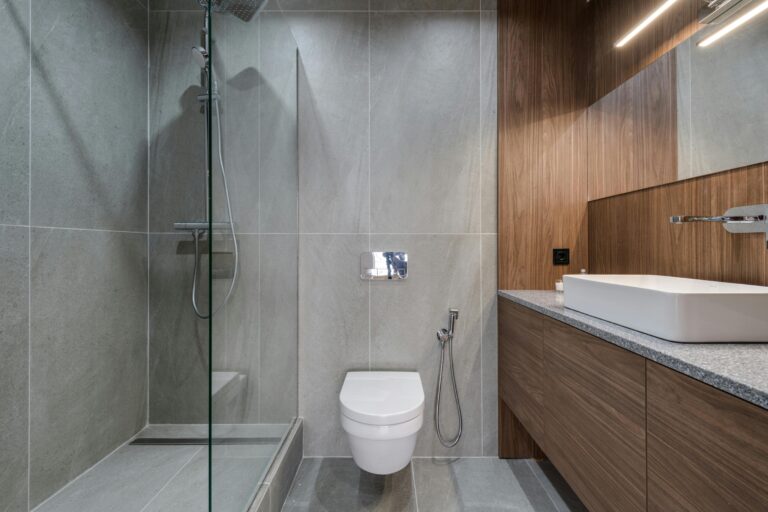 Bathroom with a shower and brown wooden vanity.